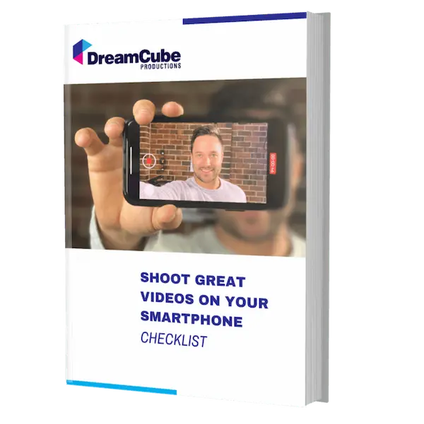 The image shows a digital book cover with the title 'Shoot Great Videos on Your Smartphone Checklist' from DreamCube Productions. The cover features a person holding a smartphone, capturing a selfie video, which represents the guide's focus on improving video skills using a smartphone.