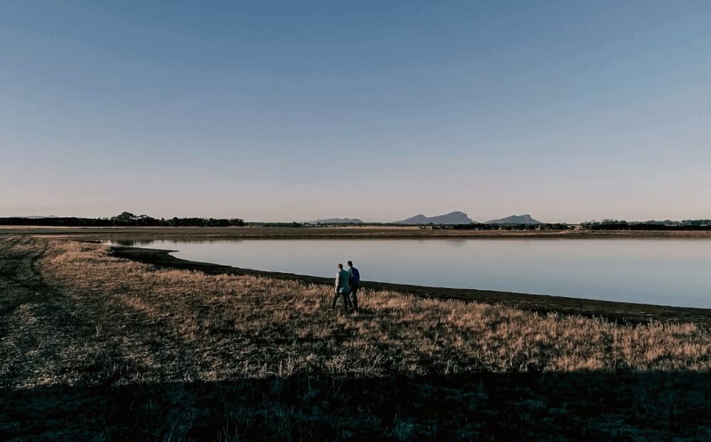 TUI Foods video: Two people walk by a lake with mountains